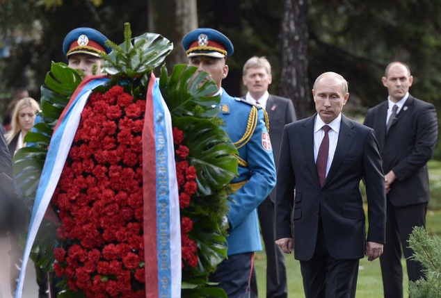 Russian President Vladimir Putin, right, lays a wreath at a monument to Soviet soldiers in Belgrade, Serbia, Thursday, Oct. 16, 2014